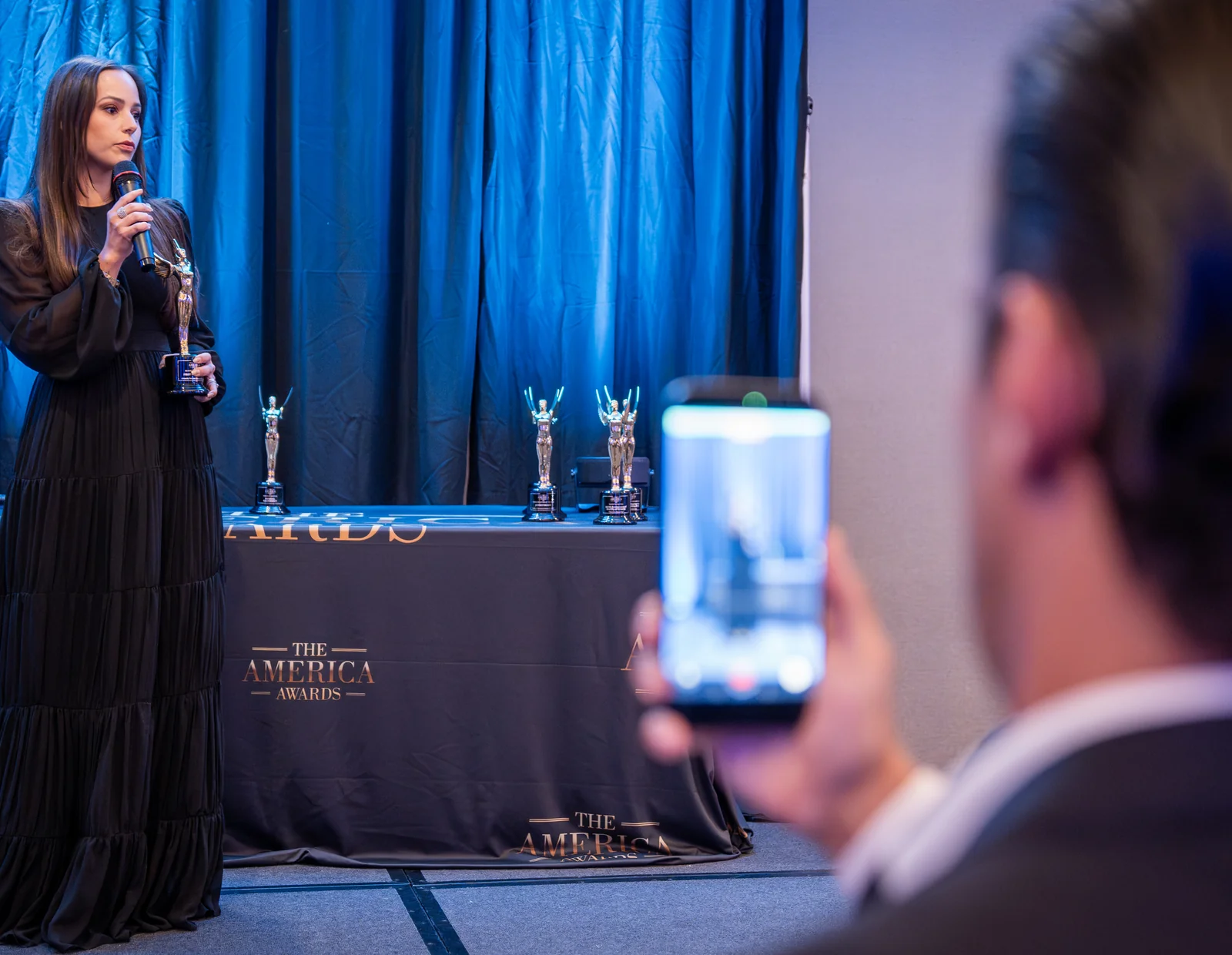 Honoree presenting The America Awards trophy